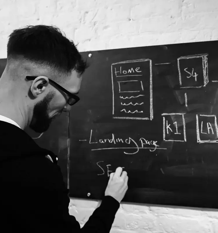 B2B digital marketing agency expert B2B marketing agency expert developing a new project idea on a chalkboard