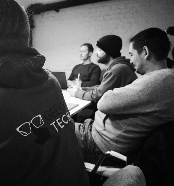 Members of the GeekyTech team in a meeting discussing SEO for Technology Companies