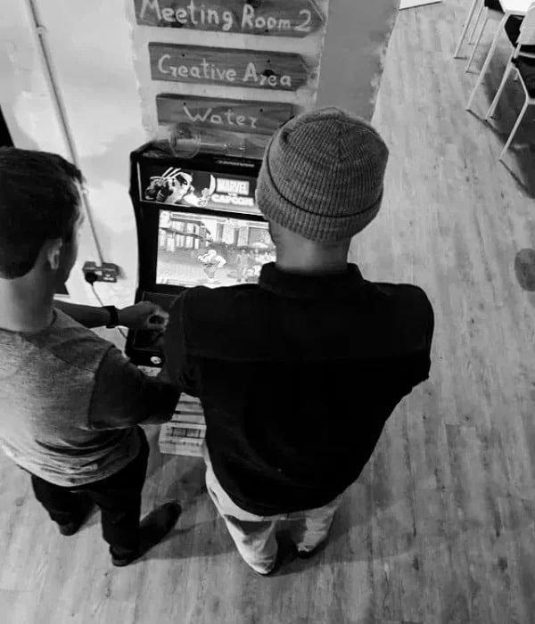 Two members of our SaaS PPC Agency taking a break playing arcade games